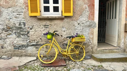 Fotobehang Fiets Old yellow decorated bike, used as house decoration.  © stefanopez