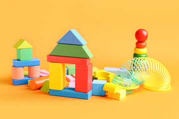 Different colorful toys on orange background. Children's Day celebration