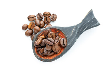 Spoon with coffee beans on white background