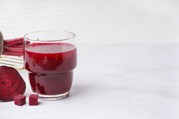 Glass of fresh beetroot juice on white background