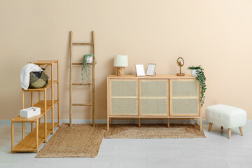 Stylish interior of living room with shelving unit, ladder, drawers and wicker rugs