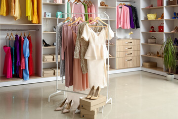 Rack with beautiful prom dresses in boutique