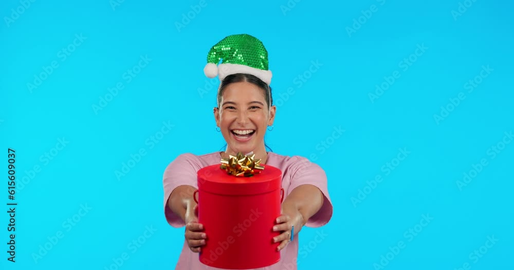 Sticker Holiday face, Christmas and a woman with a gift for happiness isolated on blue background in a studio. Happy, party and portrait of a girl giving gift for celebration or birthday with a festive box