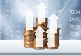 stack of golden coins with trading arrow chart