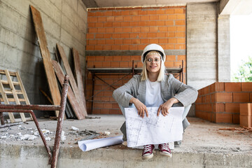 A female architect leads the construction site, overseeing progress and ensuring attention to...