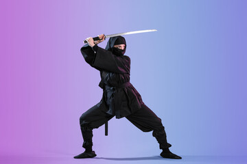 Female ninja with sword on color background © Pixel-Shot