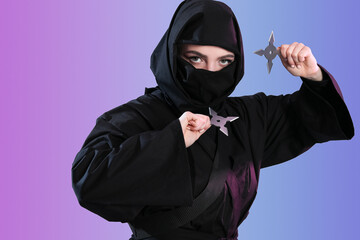 Female ninja with shurikens on color background © Pixel-Shot