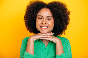 Close-up photo of an amazing charming african american or brazilian curly haired young woman with...