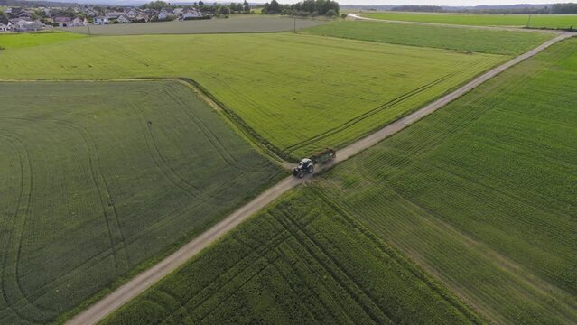 Beautiful field with moving Tractor