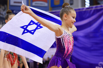 Little patriot jewish girl standing and enjoying with the flag of Israel. Patriotic holiday Independence day Israel - Yom Ha'atzmaut concept