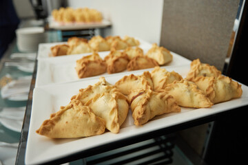 Triangular pies on a plate uchpochmak catering. © Евгений Вершинин