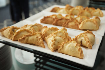 Triangular pies on a plate uchpochmak catering. © Евгений Вершинин
