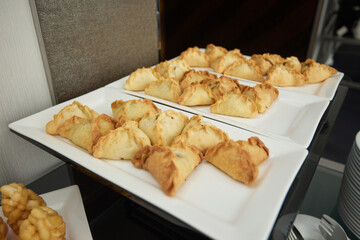 Triangular pies on a plate uchpochmak catering. © Евгений Вершинин