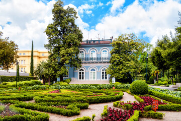 Fototapeta na wymiar Villa Angiolina with beautiful flowerbeds in front of the house, Croatia