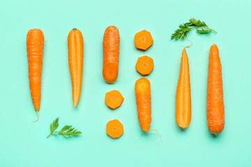 Fresh carrots and slices on turquoise background