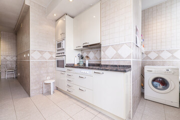 corner kitchen with white cabinets with stainless steel pulls