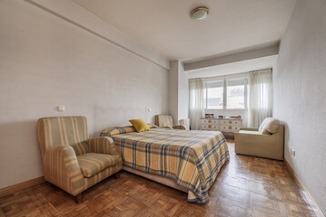 Bedroom with double bed, large checkered bedspread