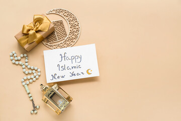 Card with text HAPPY ISLAMIC NEW YEAR, tasbih, gift box and crescent on color background