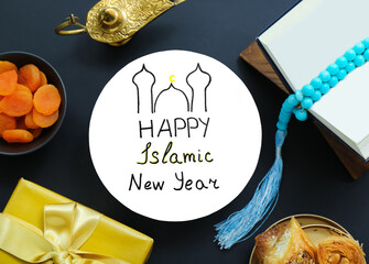 Card with text HAPPY ISLAMIC NEW YEAR, Koran and sweets on dark background, closeup