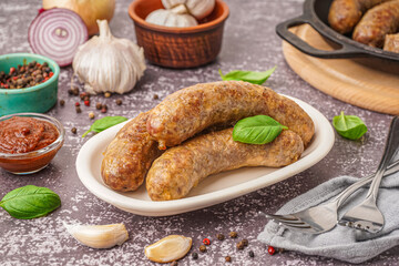 Plate of tasty homemade sausages on grunge background