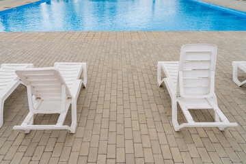 Empty sun loungers in the resort area by the pool. Background with copy space for text