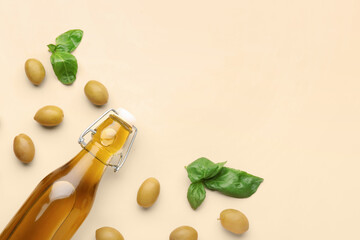 Bottle of fresh olive oil on beige background