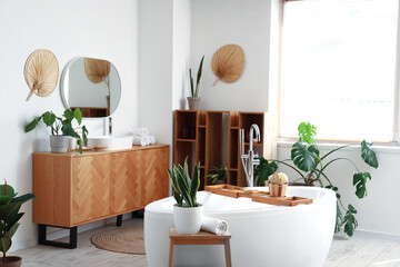 Interior of bathroom with bathtub and massage brushes