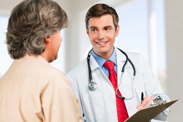 Fototapeta premium Doctor and patient during medical healthcare checkup at clinic.