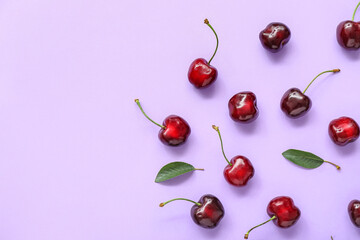 Obraz na płótnie Canvas Many sweet cherries on lilac background