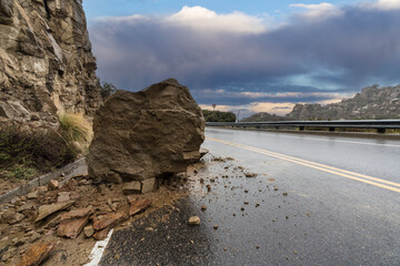 Rainy road rockslide blocking traffic lane on Santa Susana Pass Road in the Chatsworth area of Los...
