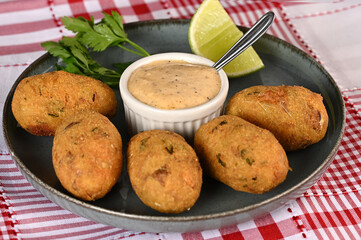 Fried codfish fritter typical Portuguese and Brazilian cuisine fish with herbs.