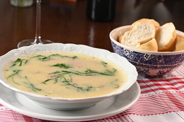 green soup, herbal cream with cassava vegan food natural healthy food with wine in the background.