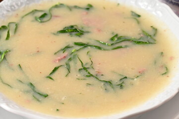 green soup, herbal cream with cassava vegan food natural healthy food with wine in the background.