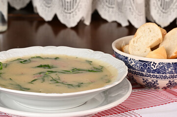 green soup, herbal cream with cassava vegan food natural healthy food with wine in the background.