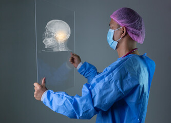 A Doctor, healthcare or futuristic skull scan in brain cancer, injury or fracture analytics in night hospital planning. Medicine, future or hologram xray of skeleton on abstract head for thinking man.