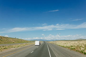 Beautiful road on a sunny day. Highway in America among the mountains. Traveling on a beautiful road. Holiday trip