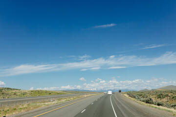 Beautiful road on a sunny day. Highway in America among the mountains. Traveling on a beautiful road. Holiday trip