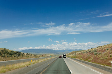 Beautiful road on a sunny day. Highway in America among the mountains. Traveling on a beautiful road. Holiday trip