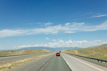 Beautiful road on a sunny day. Highway in America among the mountains. Traveling on a beautiful road. Holiday trip