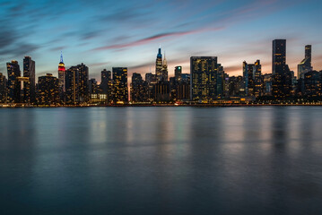 Fototapeta na wymiar Manhattan' skyline at sunset under colorful sky