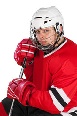 Male ice hockey player in helmet holding hockey stick on a white background