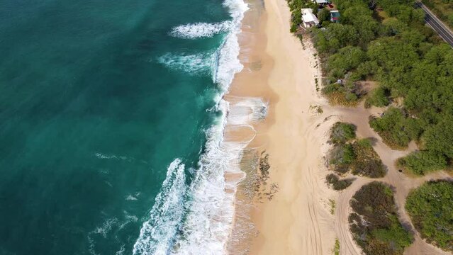 Hawaii Aerial view. Cinematic aerial view to the lonely beautiful beach. The camera moves to the mountain view. 4K Drone Footage