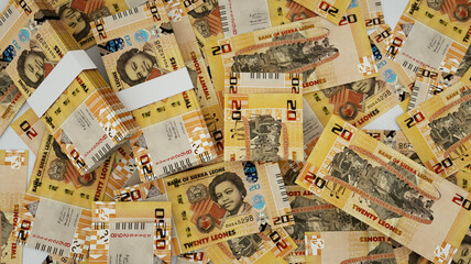 close up of 20 Sierra Leonean Leone notes spread on table. 3d rendering of money scattered on surface
