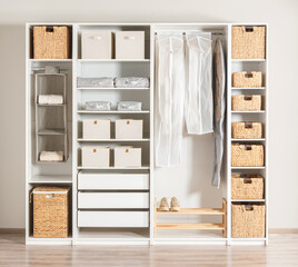 a clean and white closet with multiple drawers and shelves, providing plenty of storage space