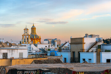 Fototapeta premium View of the Iglesia de Santa Cruz or Holy Cross Church from a rooftop in the historic Barrio Santa Cruz district of Seville, Spain.