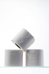 A mountain of toilet paper on a glass shelf. Hygiene.