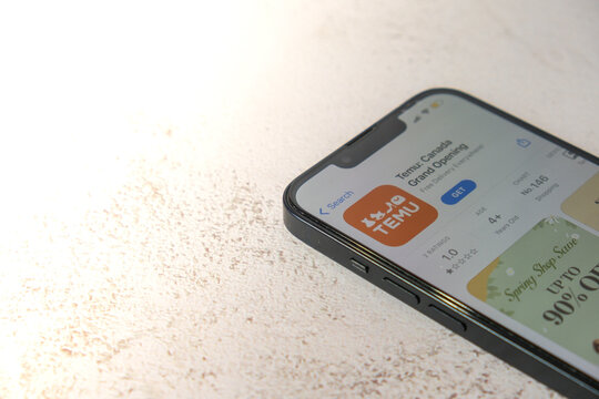Gdansk, Poland - March 2023 Temu app icon in screen of mobile phone iPhone Apple. Temu subsidiary of China based e-commerce platform Pinduoduo. Online shopping Temu website