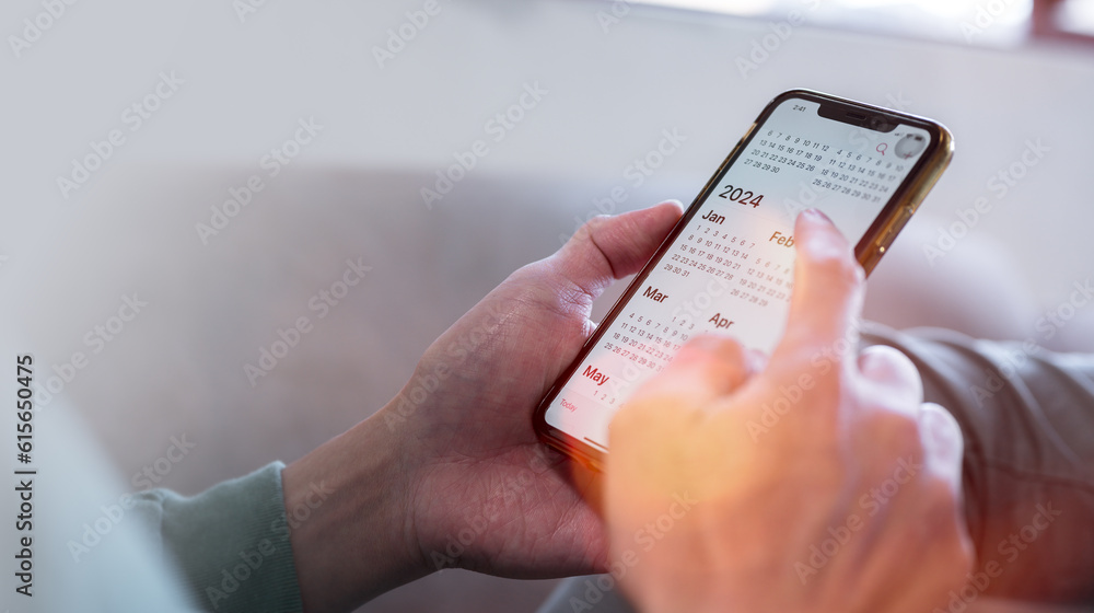 Aufkleber concept for financial planning and reminder for 2024. man using smartphone working with calendar 202