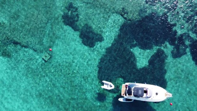 Yacht Boat anchored in Blue Lagoon of Veliki Budikovac Island floating on turquoise clear water, Croatia. Aerial