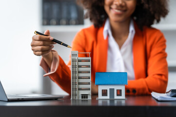 African American realtor working at desk, Housing estate, Vacancy, Prime location, Description of...